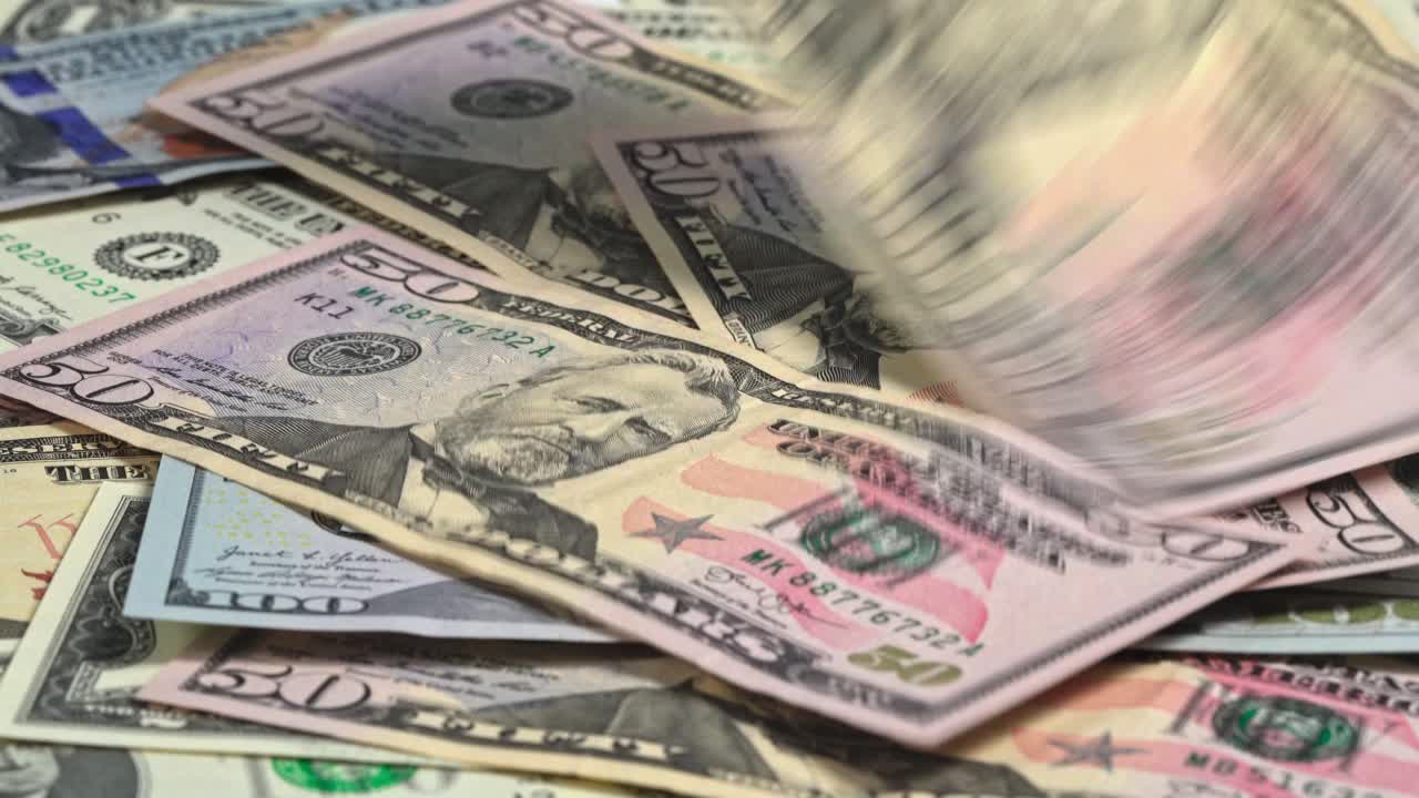 Different types of US currency arranged on a flat surface for display