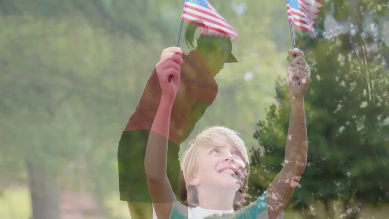 Smiling boy holding flags in park with silhouette mom lifting toddler for education marketing