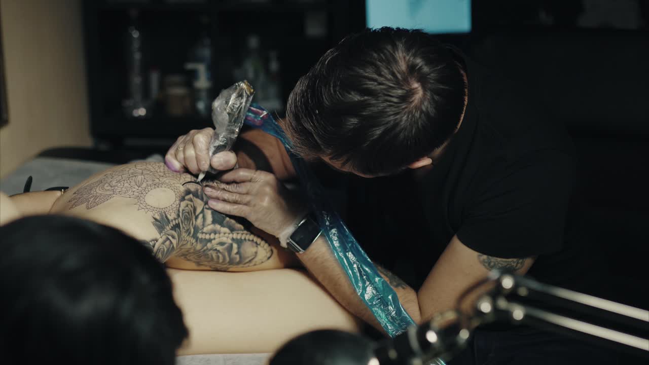 Tattoo Artist Working on a Mandala Tattoo