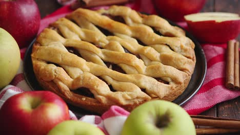 homemade pastry apple pie with bakery products on dark wooden kitchen table