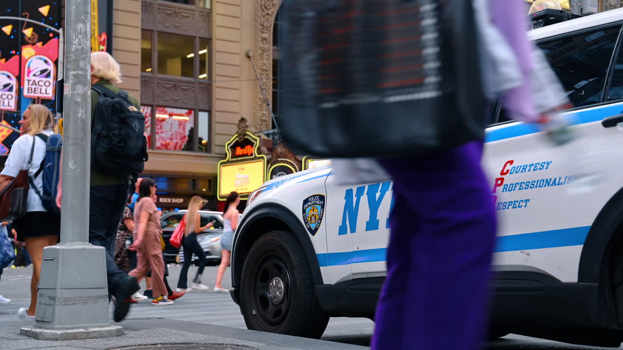 New York, USA, 16 July 2025: Close-up of NYPD car with people walking in New York. A close-up shot of an NYPD police car with pedestrians walking nearby in New York City
