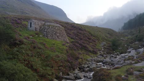 static establishing view of historic restored ice house in slieve donard, northern ireland on misty day