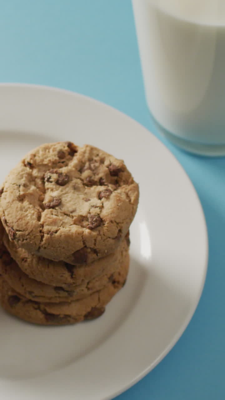 Video of biscuits with chocolate and milk on blue background