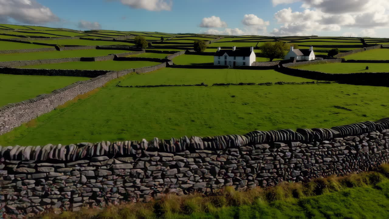 Scenic Countryside View with Stone Walls and Farmhouse