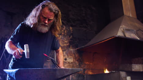 slomo slider, a blacksmith looks at his glowing iron piece in between hammering