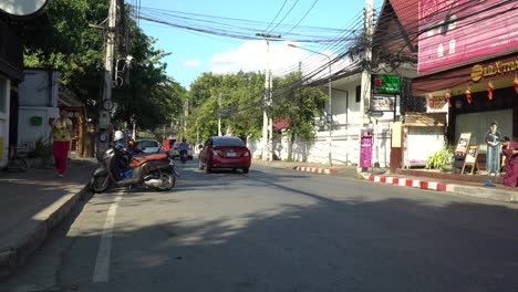 downtown chiang mai street in thailand taken from street view.   showing beautiful chiang mai streets, with bicycles, cars and rickshaw.