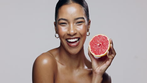 woman holding grapefruit