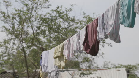 slow motion rack focus of a line of clothes drying out in the sun