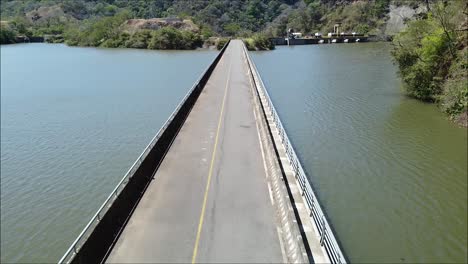 long bridge over river in costa rica, large pond with water