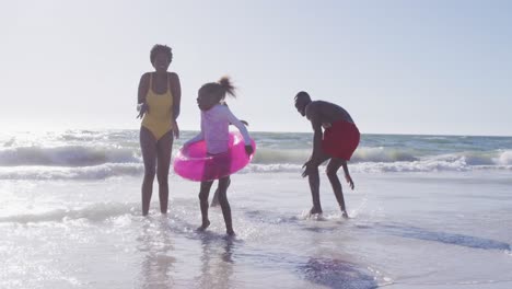 video of happy african american family having fun o beach