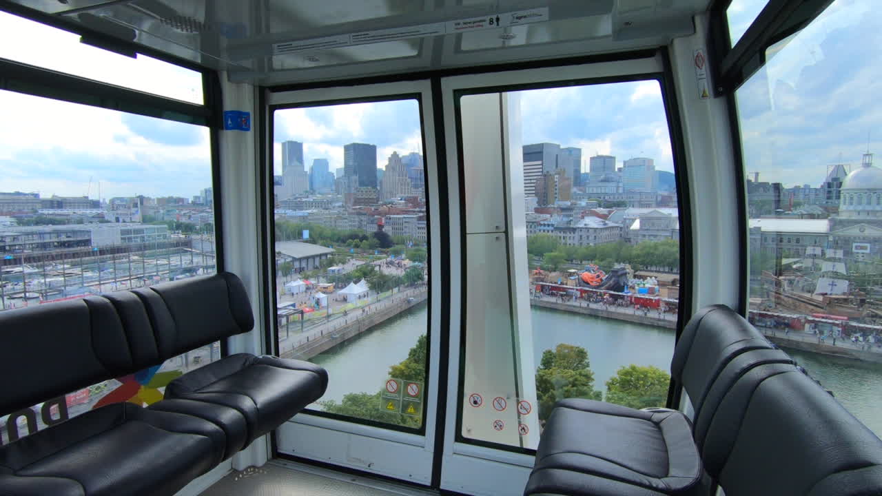 Ferris wheel cabin view, aerial view of downtown montreal, blue sky, clouds, buildings,  amusement park, ride, attraction, old-Montreal, High metal construction