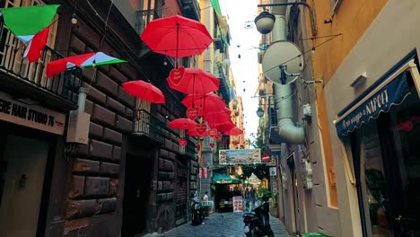 vibrant umbrellas hang above a narrow street