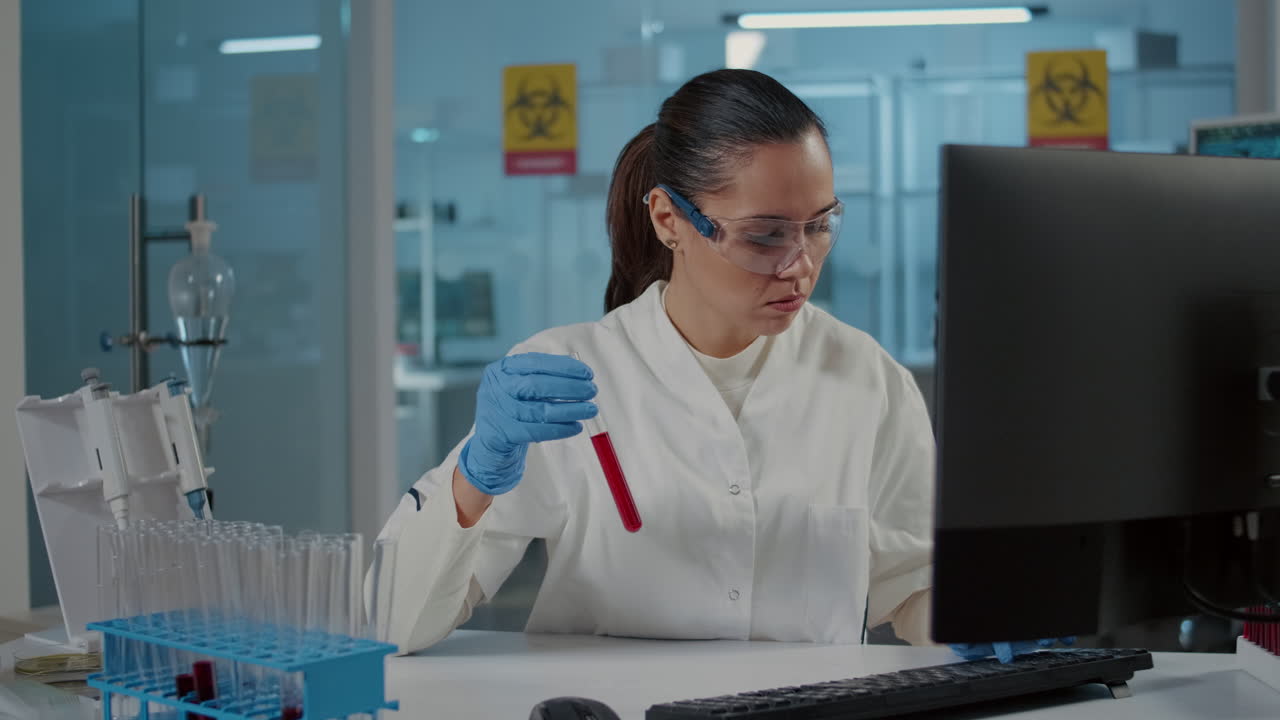Woman scientist looking at dna substance in test tube