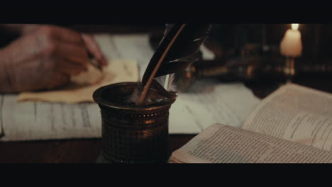 an old captain sits writes a letter inside the sailing ship cabin