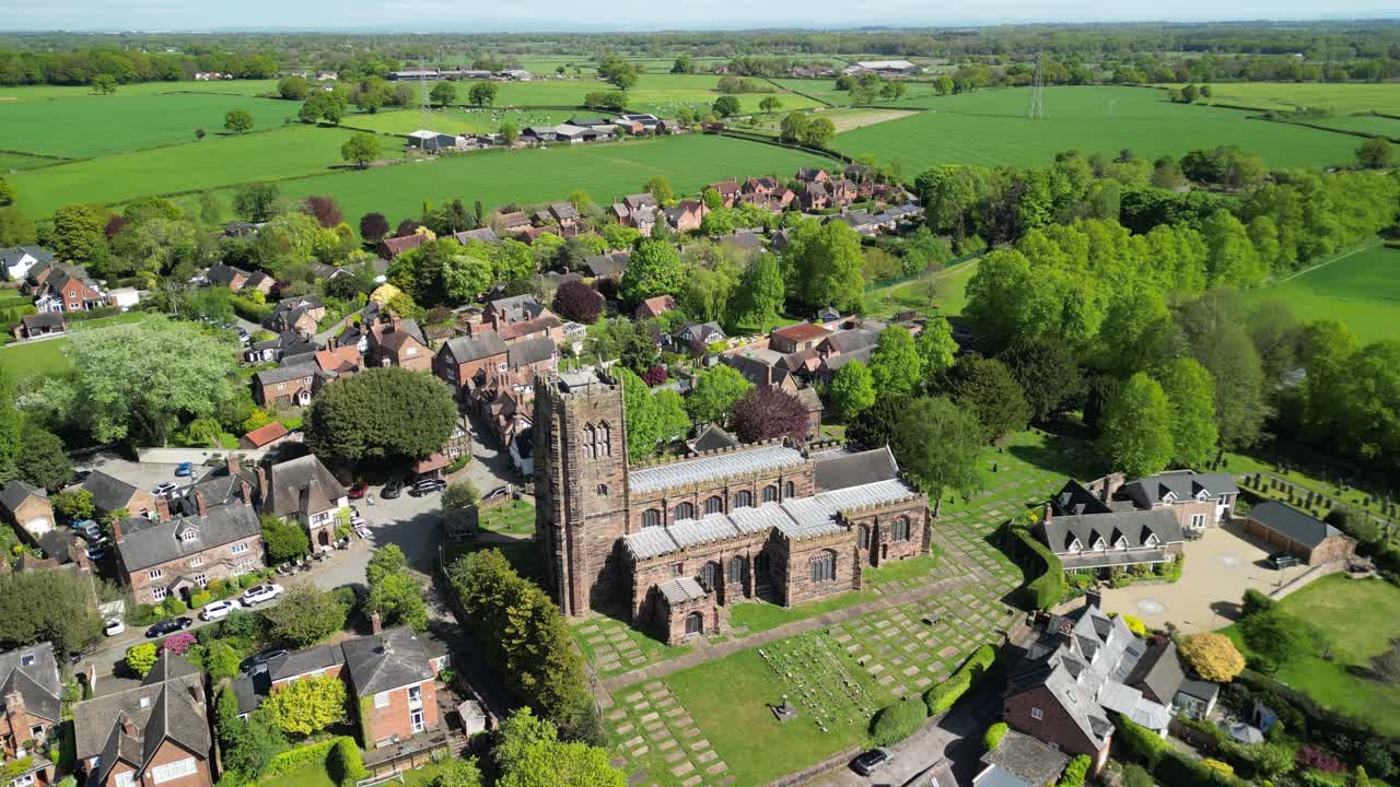 Beautiful St Mary and All Saints Church by drone in the picturesque village of Great Budworth - anticlockwise rotate from far - Cheshire, UK