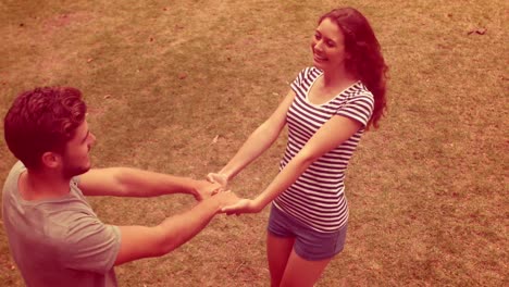 happy cute couple dancing in the park