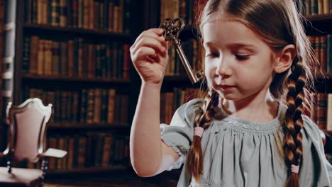 child with antique key in a library