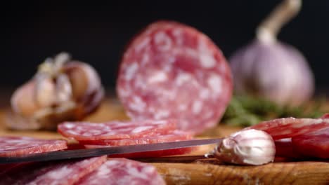 pieces of salami with a cloves of garlic.