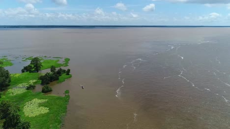 An-aerial-shot-of-a-beautiful-river-surrounded-by-green-jungle-and-indigenous-villages-in-Brasil