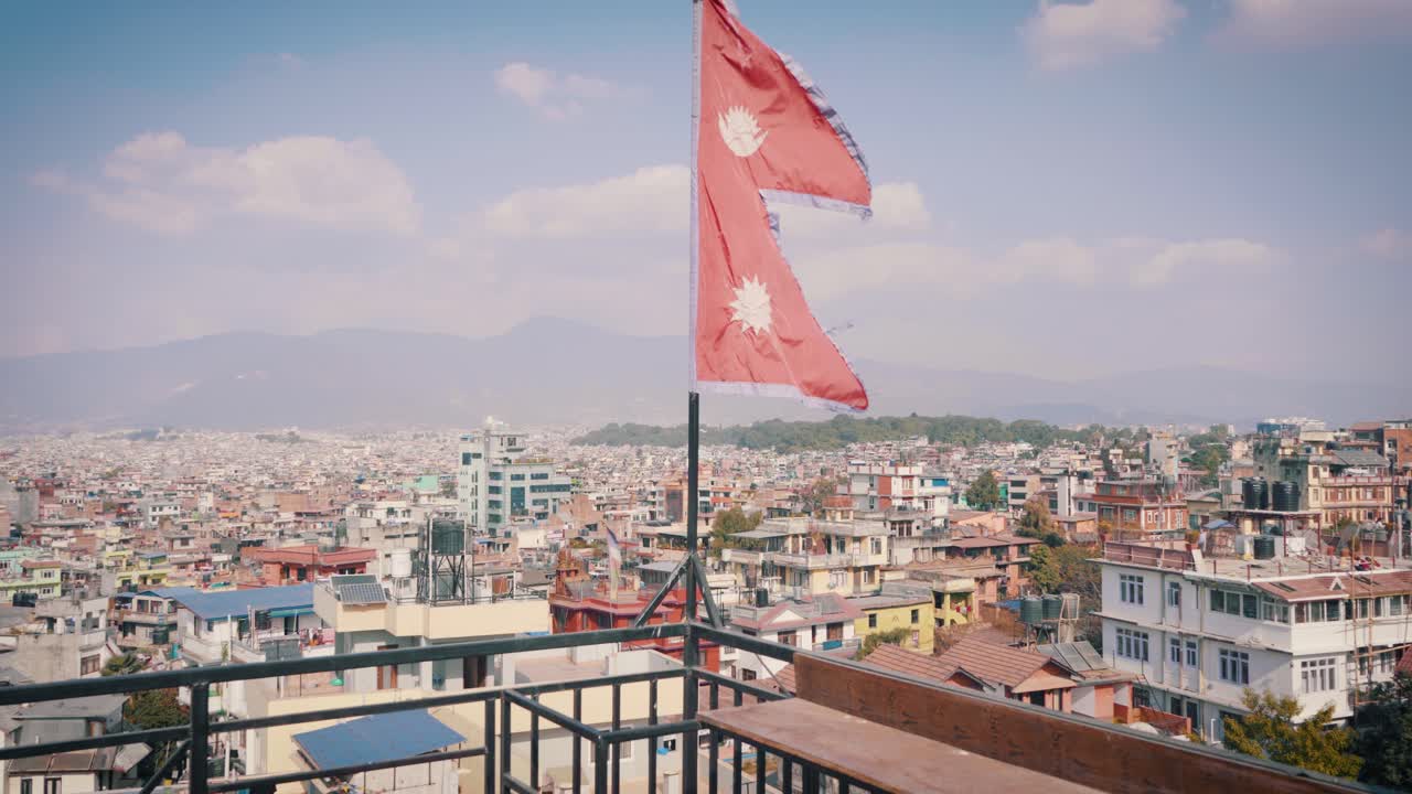 A Large Cityscape on its Background with a Flag on the Corner of the Building at Kathmandu, Nepal- Wide Shot