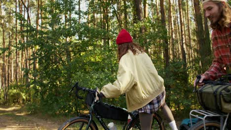 couple cycling through the forest