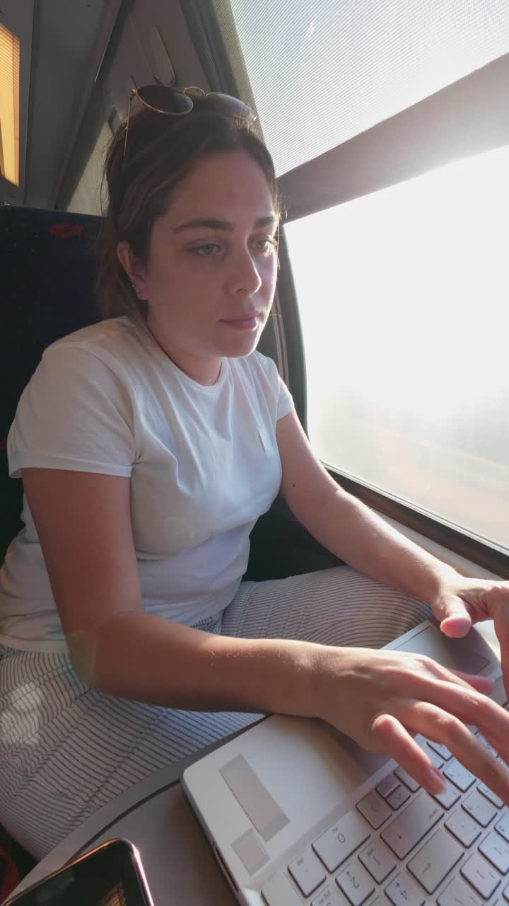 Focused Woman Working Remotely on a Laptop During a Journey