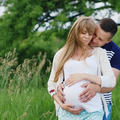 man and pregnant woman embrace