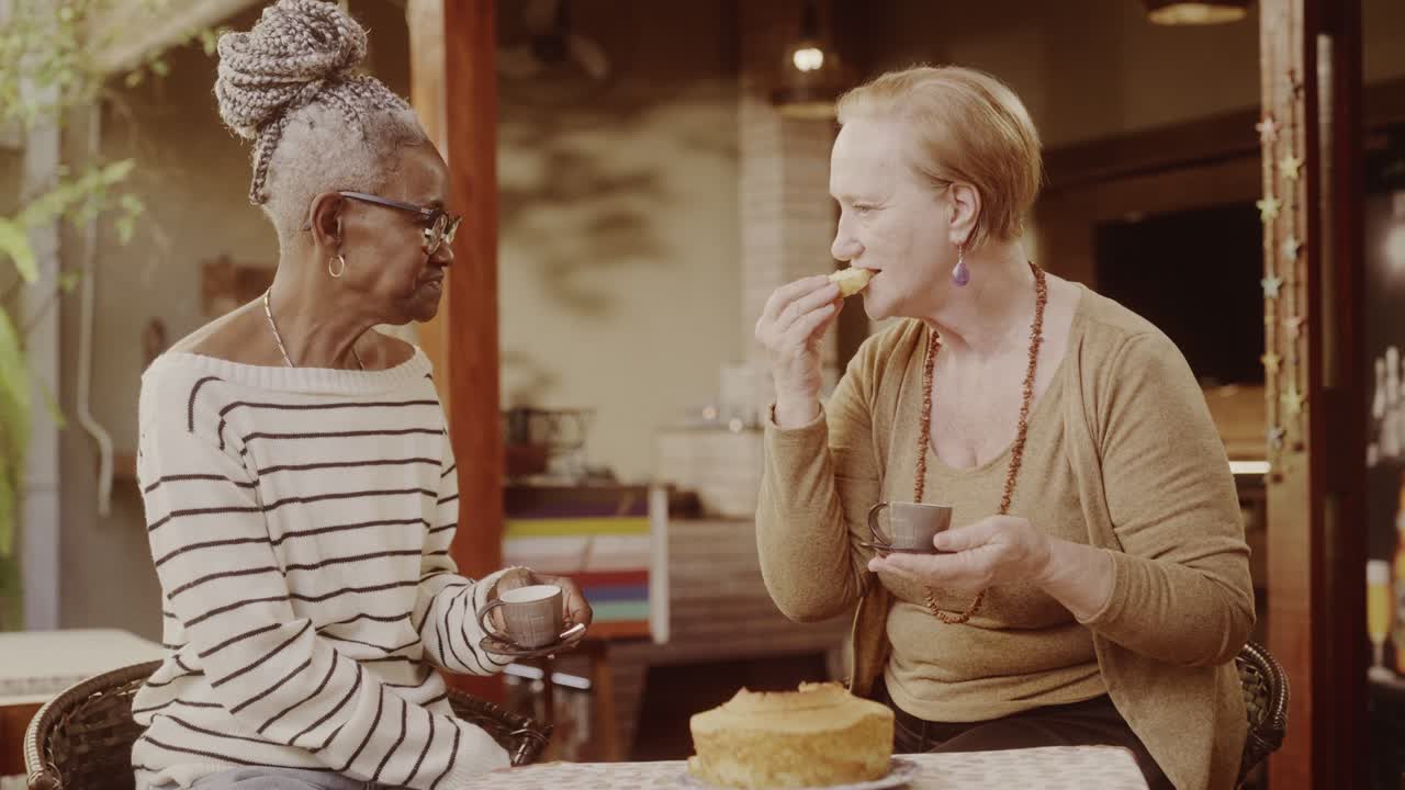 Two Elderly Women Enjoying Tea and Cake Outdoors