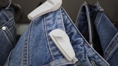 jeans with anti-theft tags on display