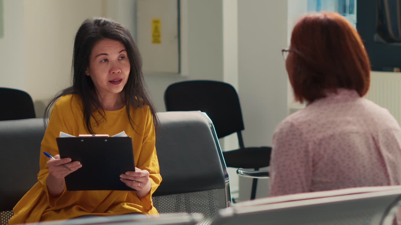 Two people talking in a waiting room
