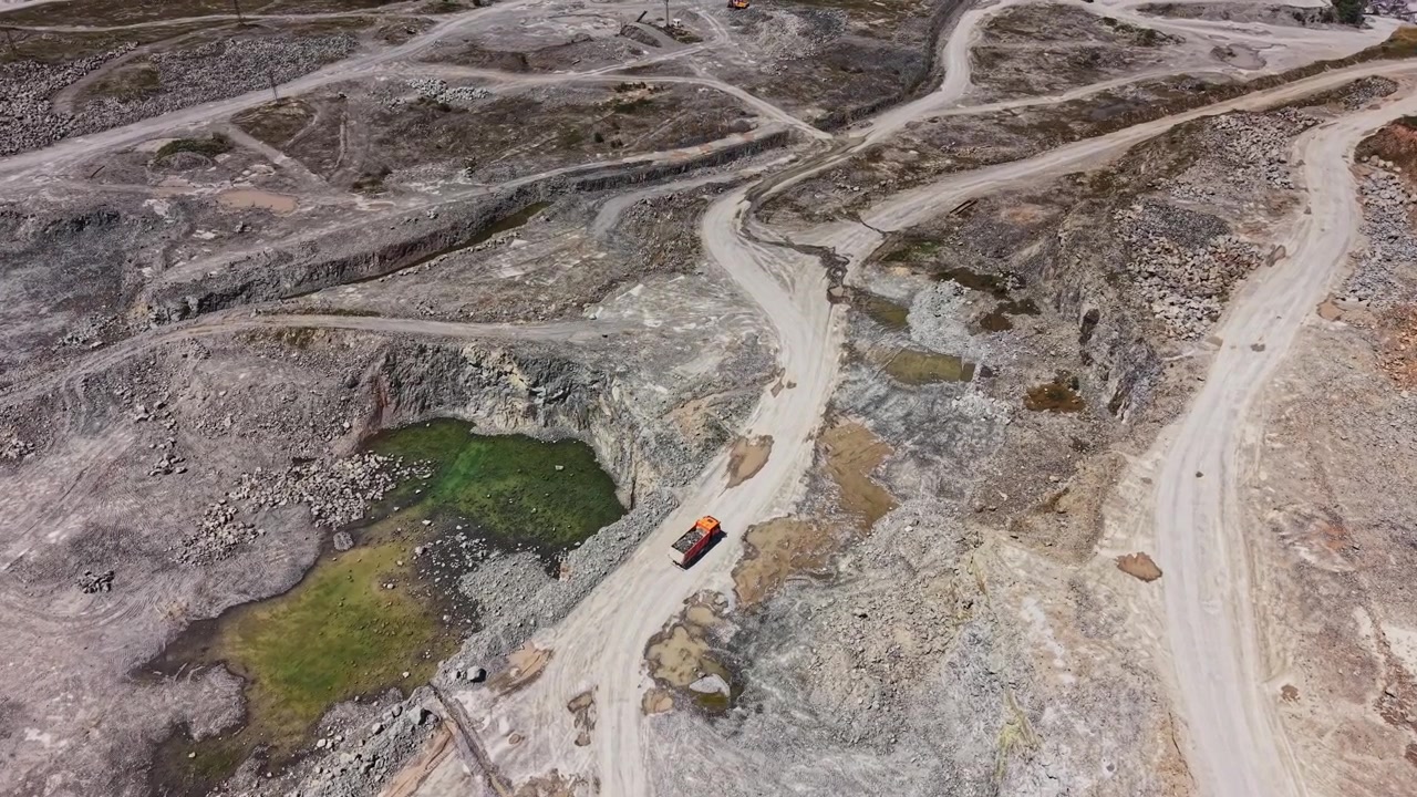 View of a construction site during daytime showing machinery and dirt roads