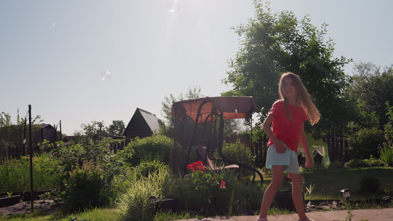 Child Spins Happily, Girl Dances Joyfully Outside In Garden, Bright Sun Illuminates Girl Spinning Amid Colorful Flowers, Child Joyfully Twirls Outdoors Under Radiant Sunshine Among Blooming Flowers