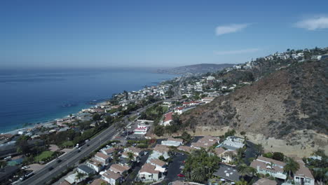 cinematic aerial shot overlooking laguna beach, california with both the mountains and the ocean in view