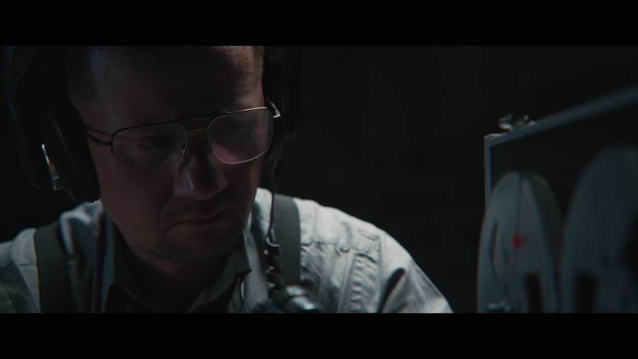 An intelligence officer listens to the wiretap recordings