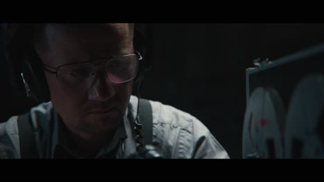an intelligence officer listens to the wiretap recordings