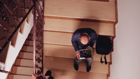 Unhappy-fired-entrepreneur-sitting-on-stairs