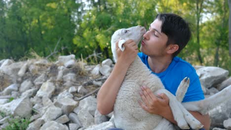 young man kissing lamb