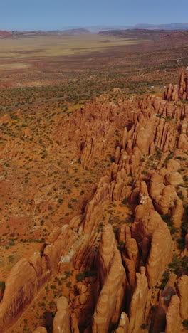 deserted landscape with amazingly-shaped rocks from air erosion. arches national park canyons from aerial view. vertical video