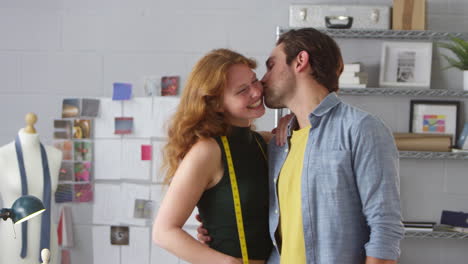 portrait of loving couple running clothes design business standing together in fashion studio