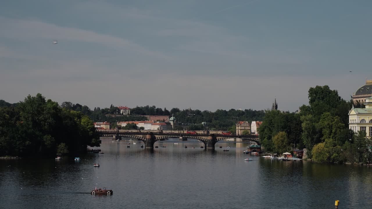 Vltava River with boats and the historic Legion Bridge connecting Prague districts
