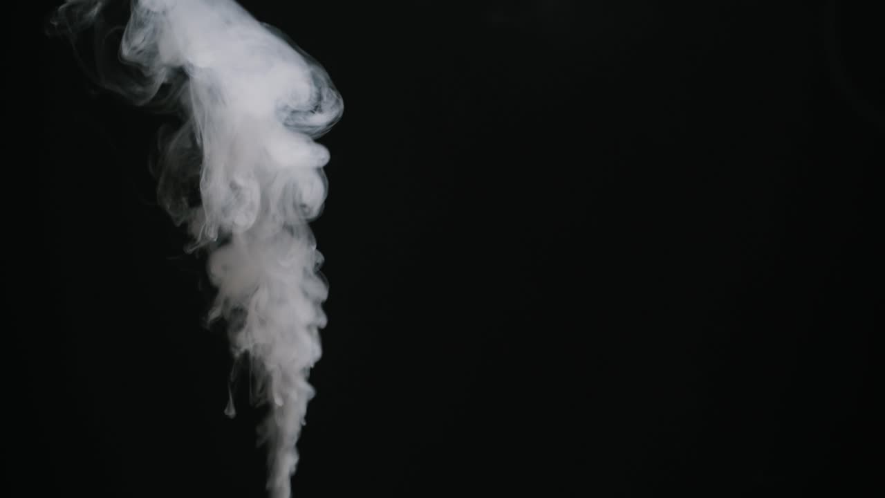 Dense White Smoke Rising and Flowing on Black Background