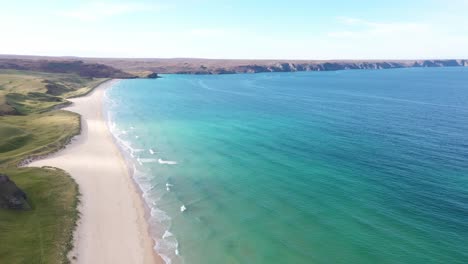 tilting drone shot from the headland and sheer cliffs to the northern terrain at traigh mhor beach in tolsta village on the outer hebrides of scotland