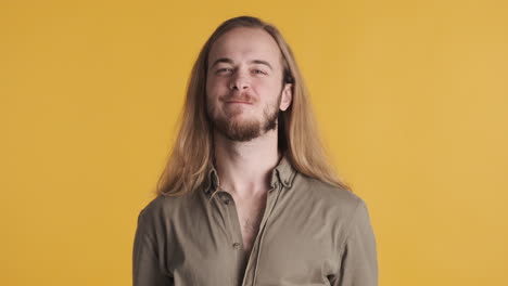 caucasian young man celebrating victory in front of the camera.