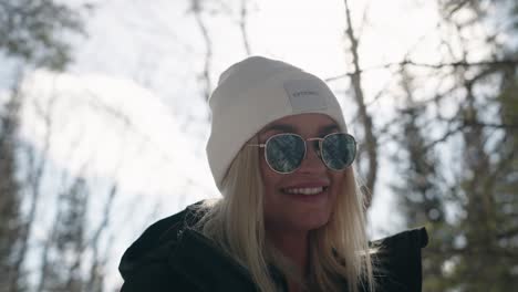 young caucasian woman smiling with bright sunlight in background