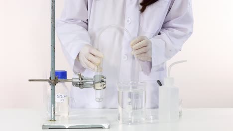 el científico lleva a cabo la descomposición del carbonato de cobre en el laboratorio
