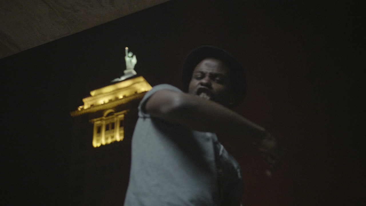 African American male dancer at night in the city