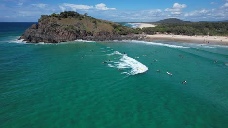 surfers at cabarita beach during summer in new south wales, australia - aerial shot