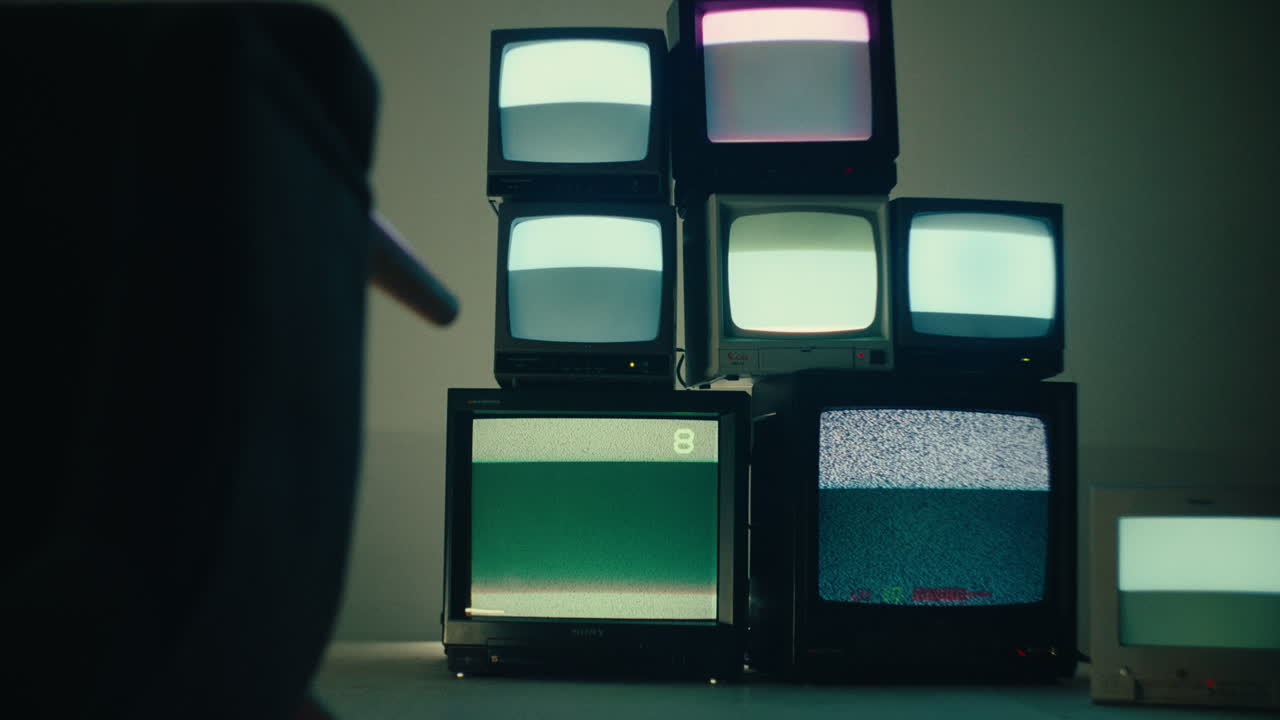 chair flip over in a media room studio with old crt monitor displaying glittering noise signal