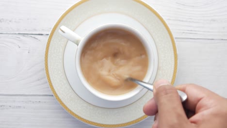 stirring tea in a cup
