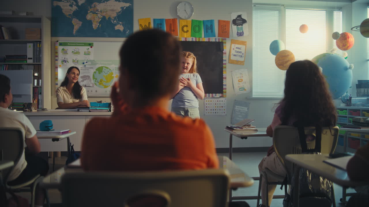 Primary School Girl Showcasing Knowledge of Geography in Front of Class and Teacher Using Digital